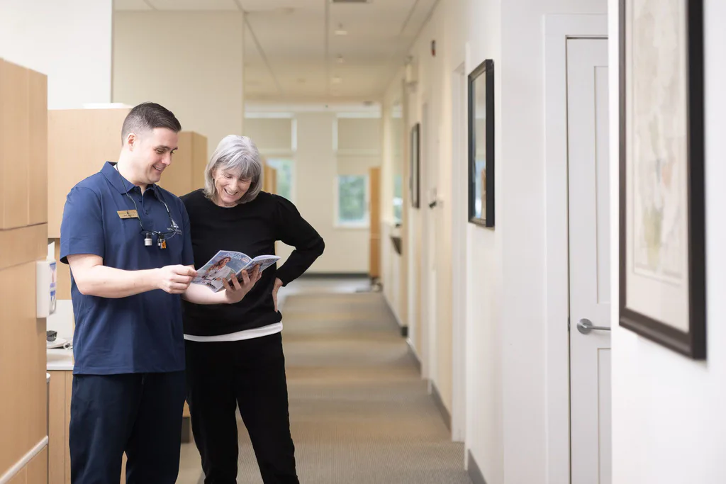 Dr. Séguin reviewing information with a patient in the hallway