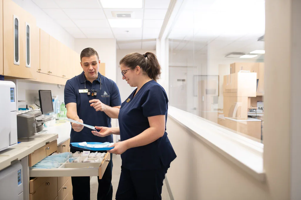 Dr. Séguin and an assistant selecting instruments from a prepared drawer