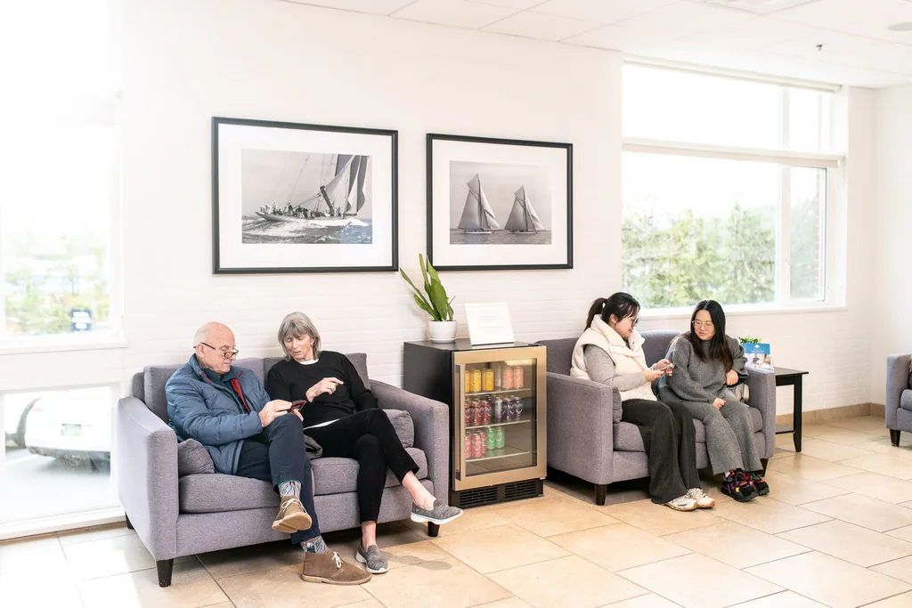 The lounge with soft seating and framed black-and-white sailing photographs