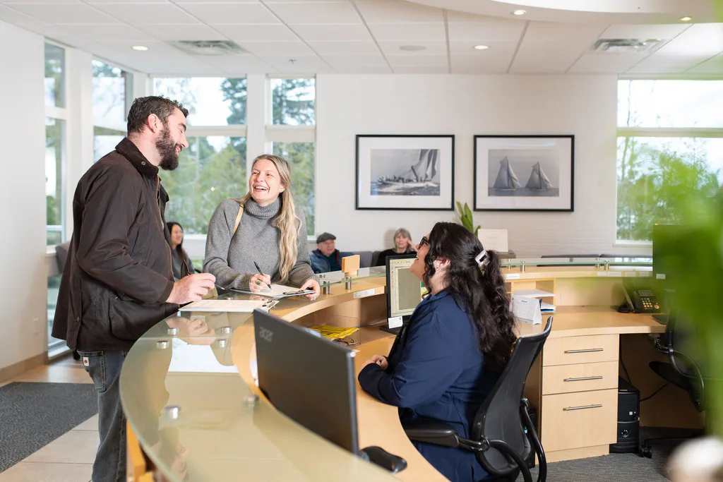 A patient chatting with the front desk team