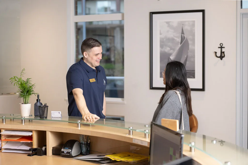 Dr. Séguin talking with a patient across the reception desk