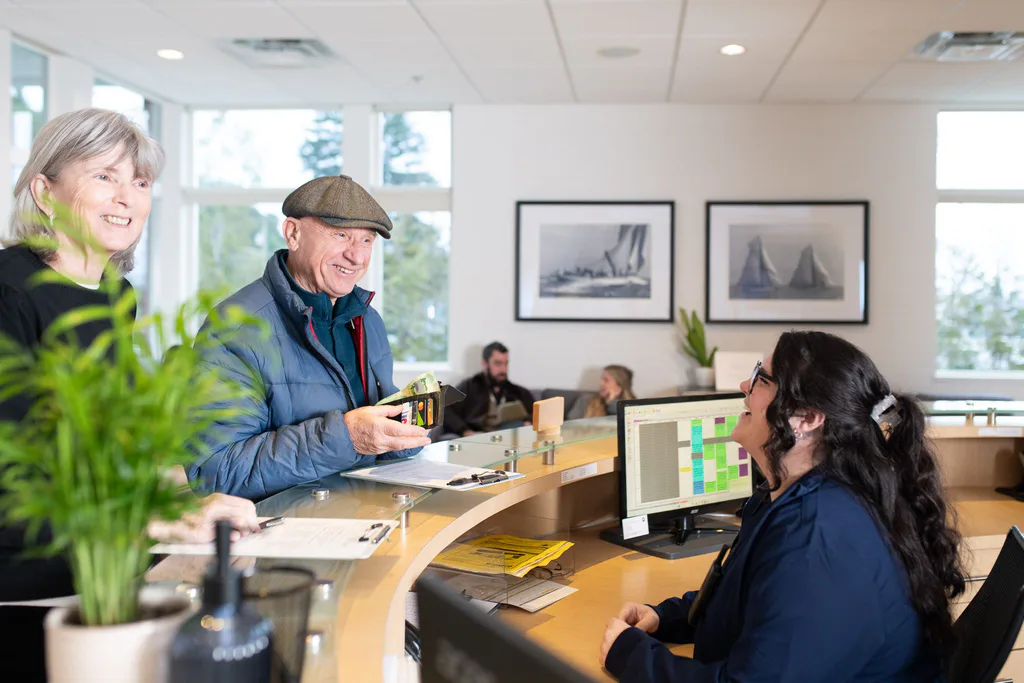 A patient chatting with the front desk team at check-in